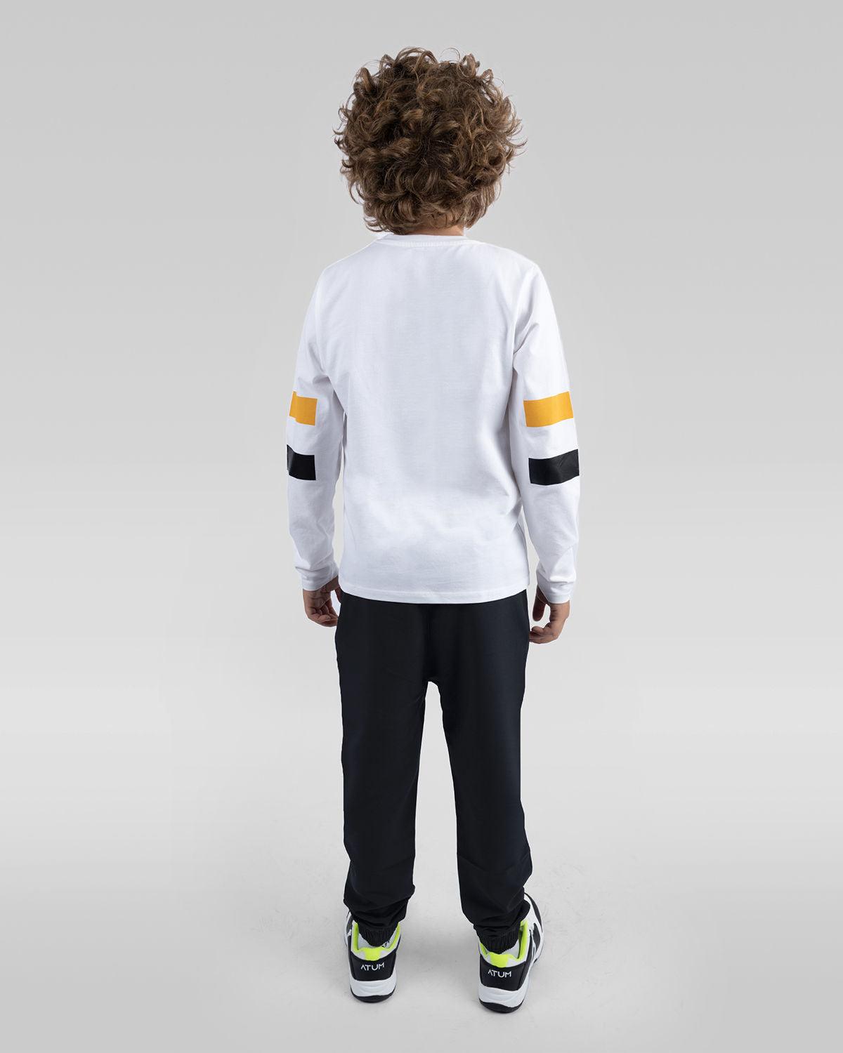 Photo by ð—”ð—§ð—¨ð— SPORTSWEAR Â® on December 20, 2022. May be an image of 1 boy wears a white T-shirt, black sweatpants and a white shoes with atum logo.