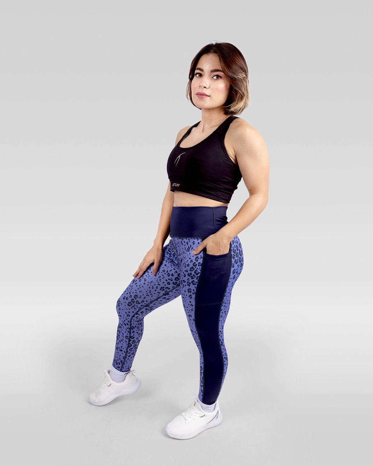 Photo by ð—”ð—§ð—¨ð— SPORTSWEAR Â® on December 20, 2022. May be an image of 1 woman wears printed purple/navy floral leggings, and black sports bra with white shoes.