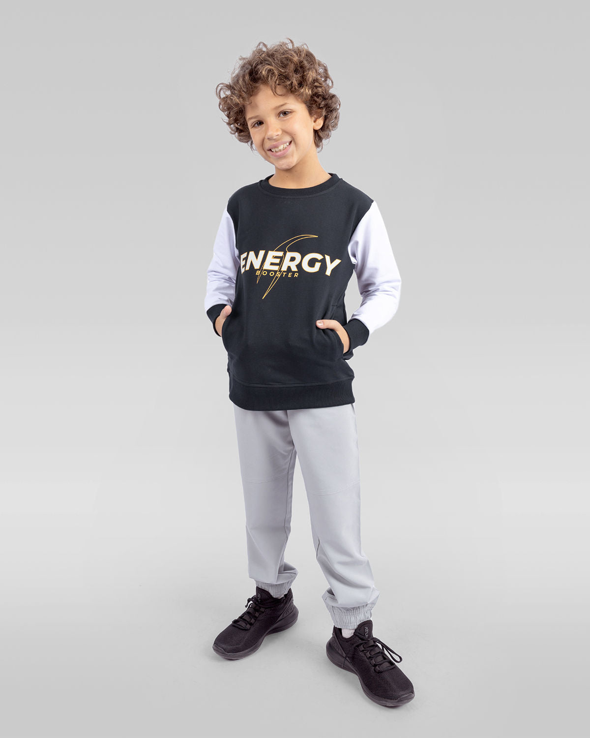 Photo by 𝗔𝗧𝗨ð�— SPORTSWEAR ® on December 20, 2022. May be an image of 1 boy wears a Black sweatshirt and gray sweatpants and a black shoes with a text said '' energy''.