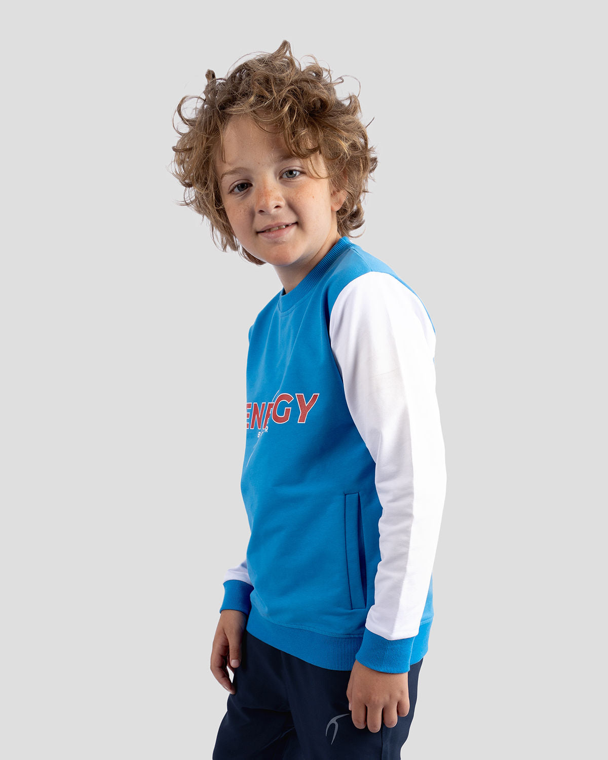 Photo by ð—”ð—§ð—¨ð— SPORTSWEAR Â® on December 20, 2022. May be an image of 1 boy wears a Blue sweatshirt and a text said '' energy''.