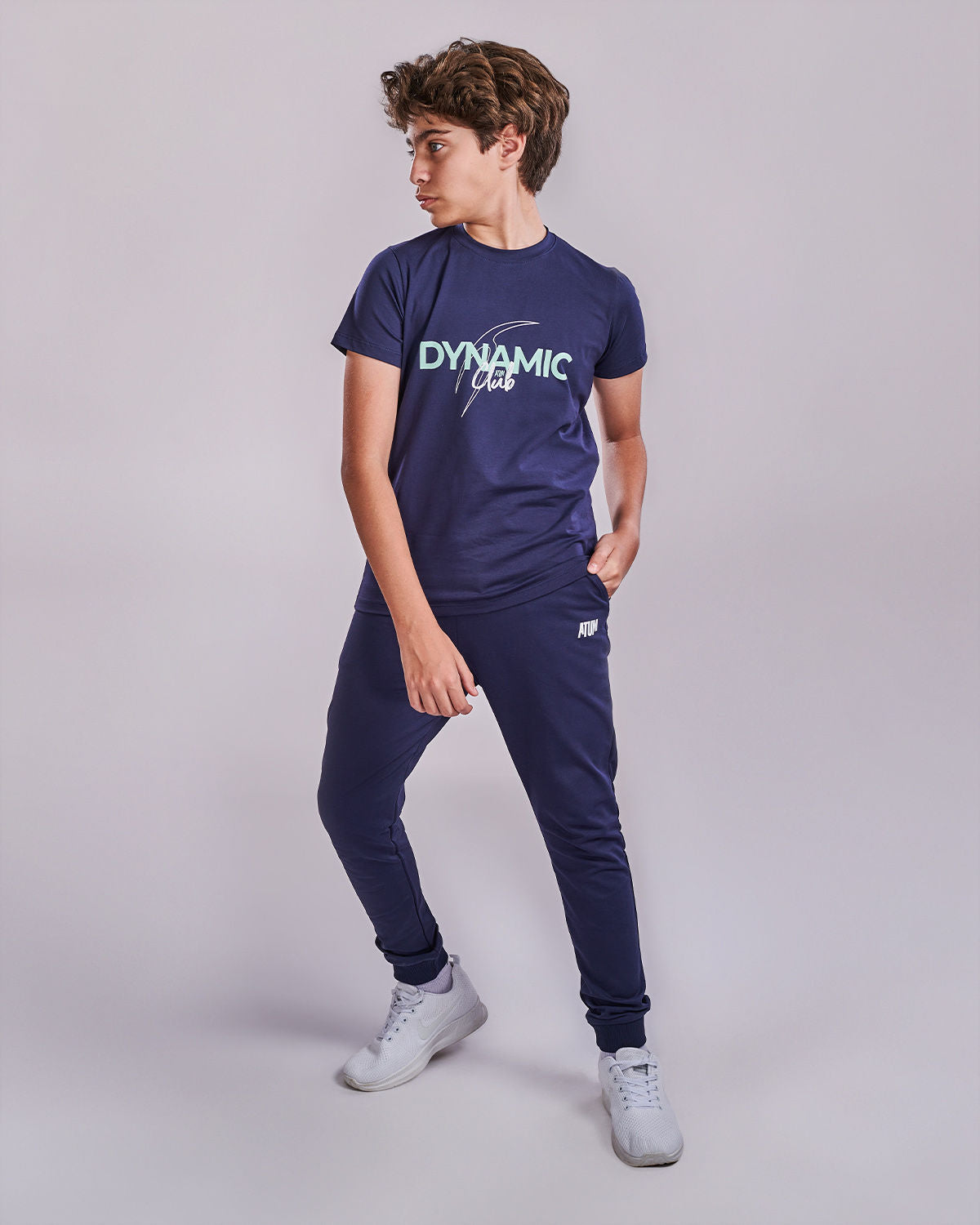 Photo by 𝗔𝗧𝗨𝗠 SPORTSWEAR ® on May 22, 2022. May be an image of 1 boy wears a navy t-shirt with a text ''Dynamic club", and a navy sweatpants.