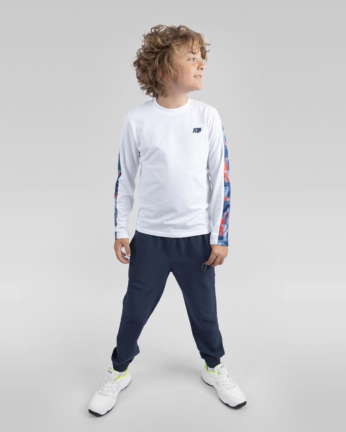 Photo by 𝗔𝗧𝗨ð�— SPORTSWEAR ® on December 20, 2022. May be an image of 1 boy wears a navy sweatpants with a white t-shirt and a white shoes.