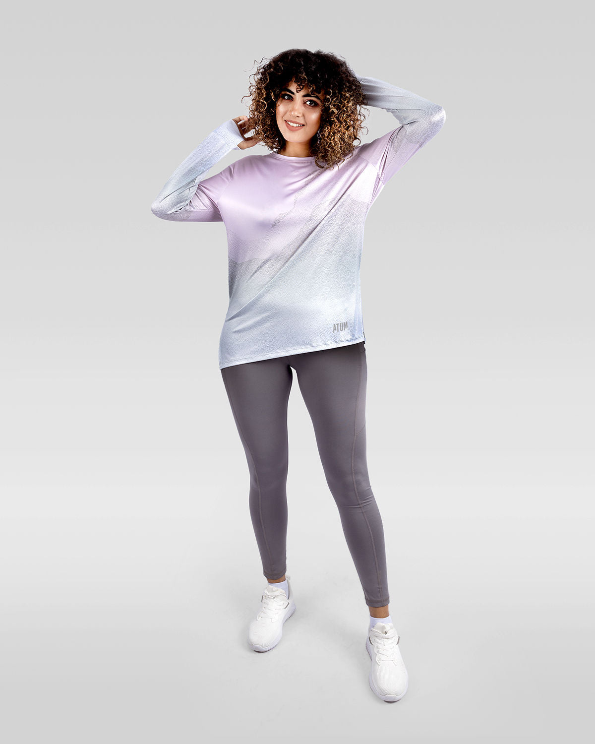 Photo by ð—”ð—§ð—¨ð— SPORTSWEAR Â® on December 20, 2022. May be an image of 1 woman wears rose gradient t-shirt, gray leggings and white shoes.