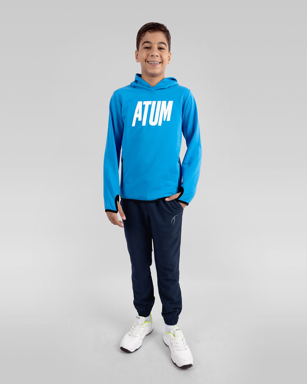 Photo by 𝗔𝗧𝗨ð�— SPORTSWEAR ® on December 20, 2022. May be an image of 1 boy wears a blue sweatshirt, a navy sweatpants and a white shoes with a text said '' Atum''.