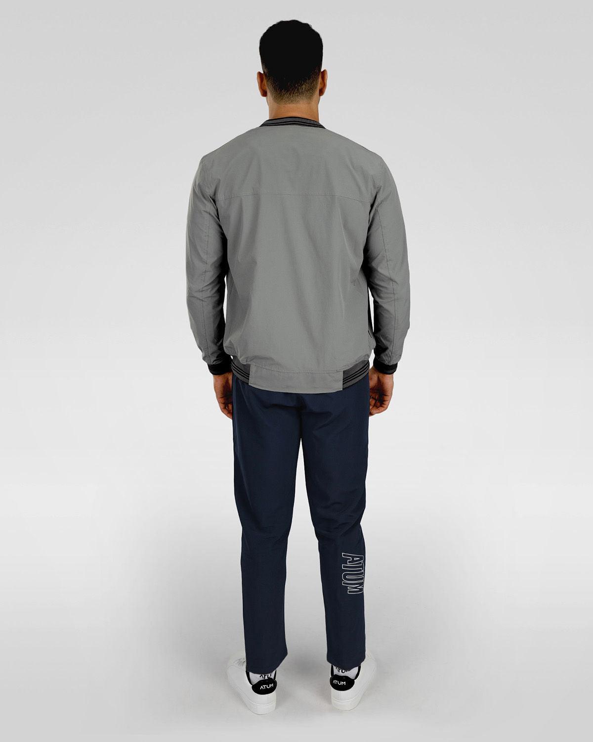 Photo by 𝗔𝗧𝗨ð�— SPORTSWEAR ® on December 20, 2022. May be an image of 1 man wear gray jacket with white basic t-shirt, and navy sweatpants with white shoes.