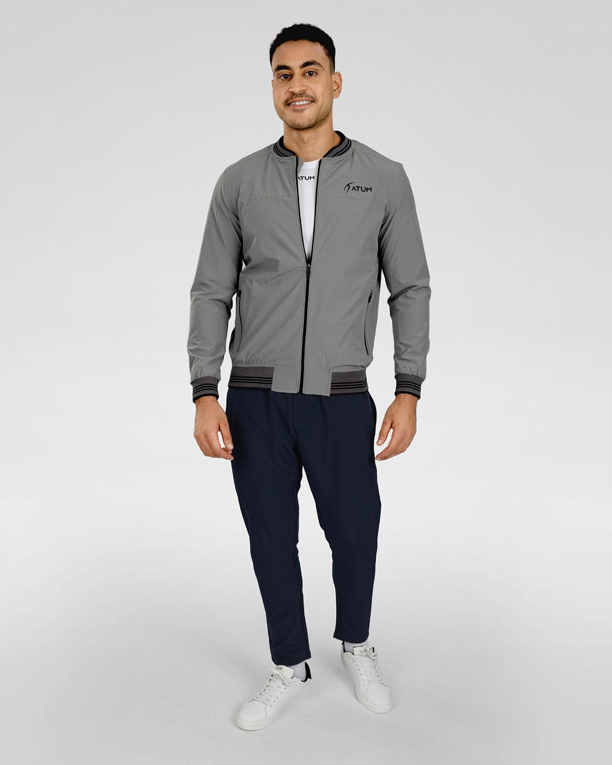 Photo by 𝗔𝗧𝗨ð�— SPORTSWEAR ® on December 20, 2022. May be an image of 1 man wear gray jacket with white basic t-shirt, and navy sweatpants with white shoes.