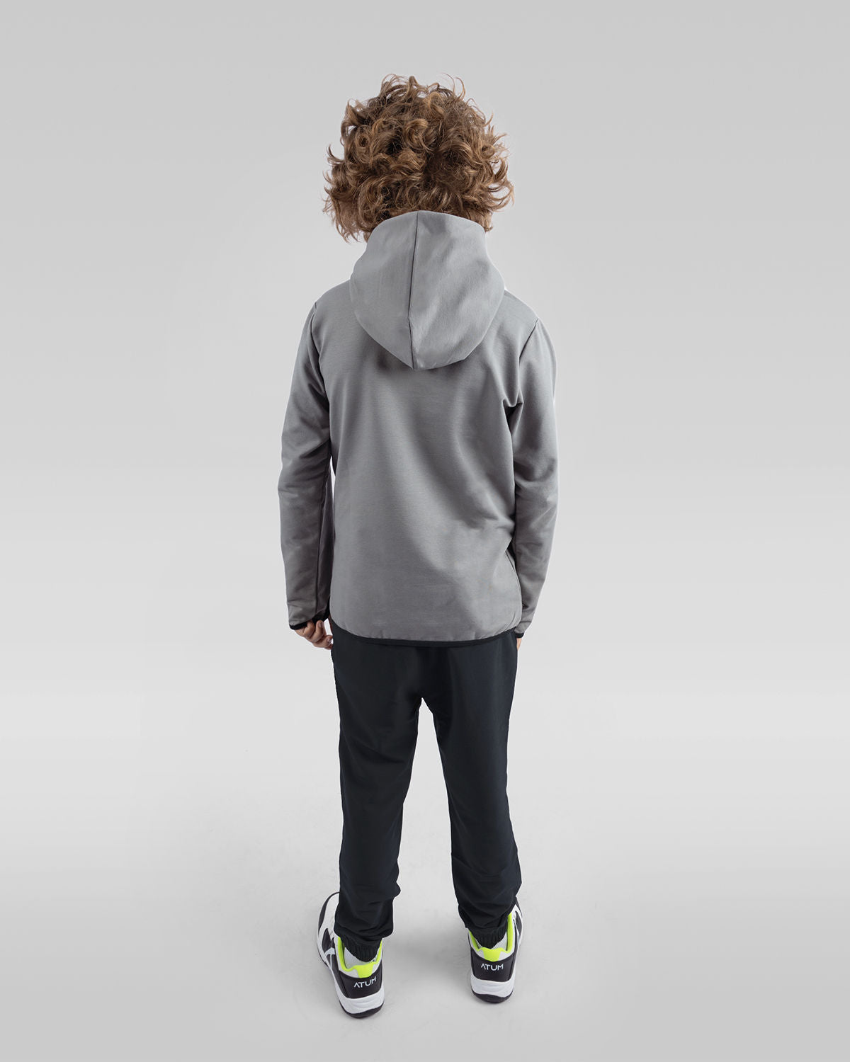 Photo by ð—”ð—§ð—¨ð— SPORTSWEAR Â® on December 20, 2022. May be an image of 1 boy wears a gray sweatshirt, a black sweatpants and a white shoes with a text said '' Atum''.