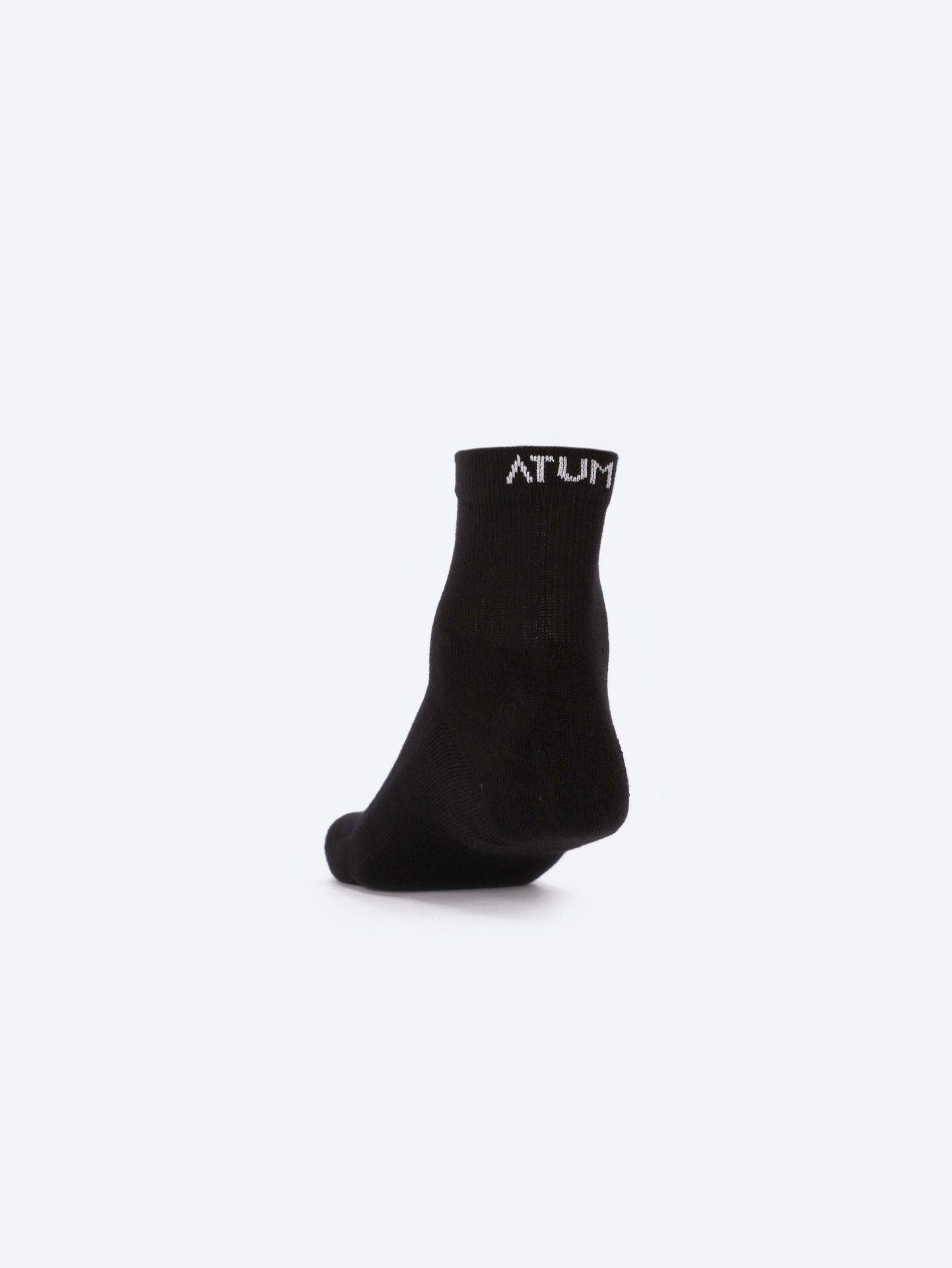 Photo by ð—”ð—§ð—¨ð— SPORTSWEAR Â® on December 26, 2022. May be of one black socks with atum logo.