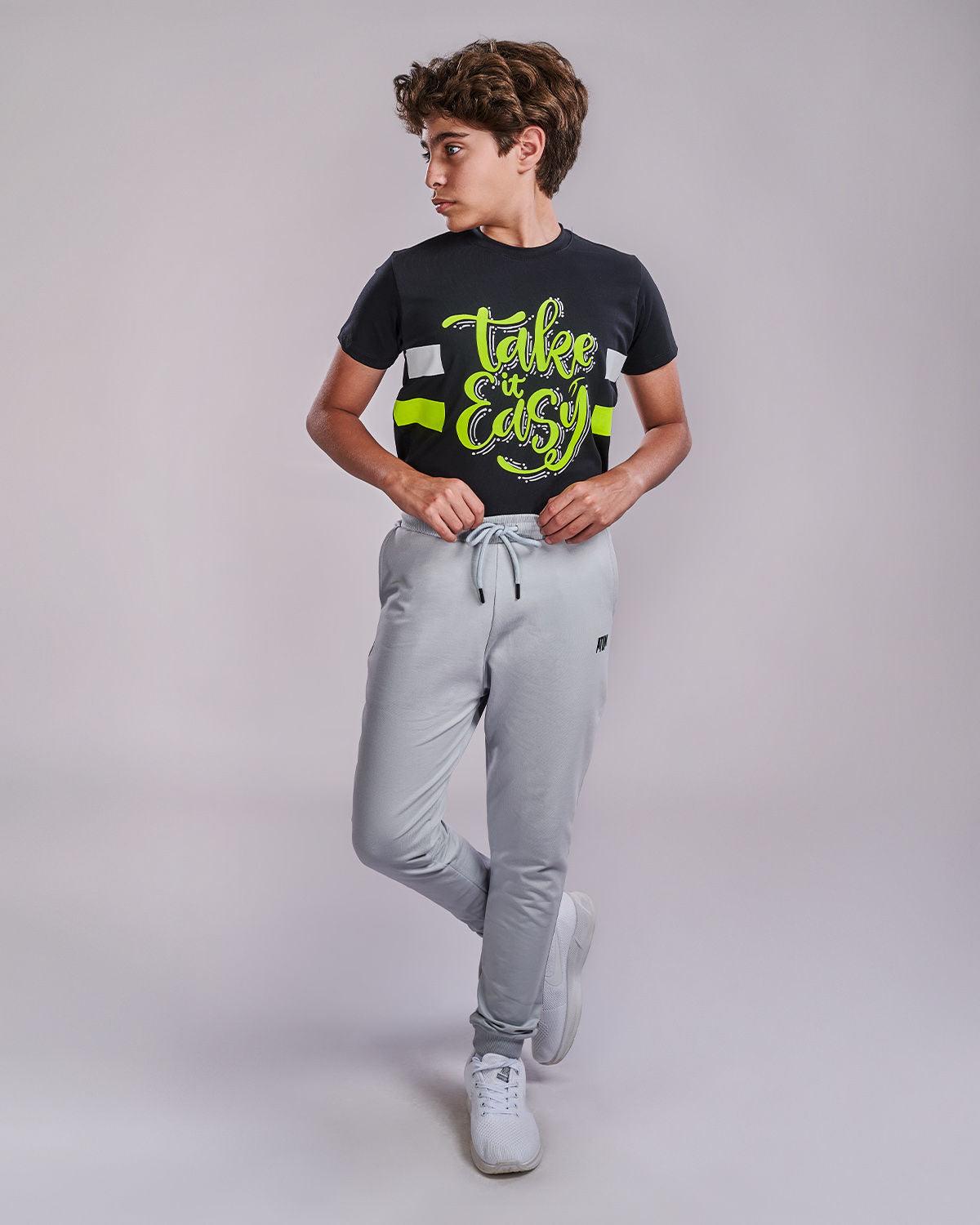Photo by ð—”ð—§ð—¨ð— SPORTSWEAR Â® on December 20, 2022. May be an image of 1 boy wears gray sweatpants, and a black t-shirt with a text said '' take it easy''.