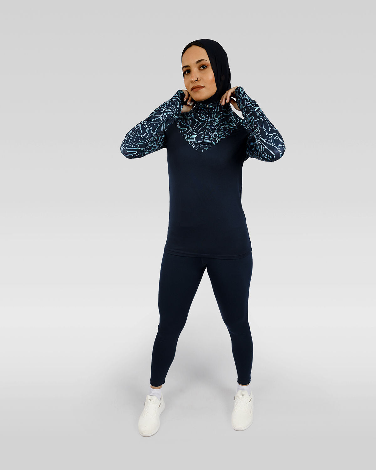 Photo by ð—”ð—§ð—¨ð— SPORTSWEAR Â® on December 20, 2022. May be an image of 1 woman wears navy training t-shirt, navy leggings ,and white shoes.