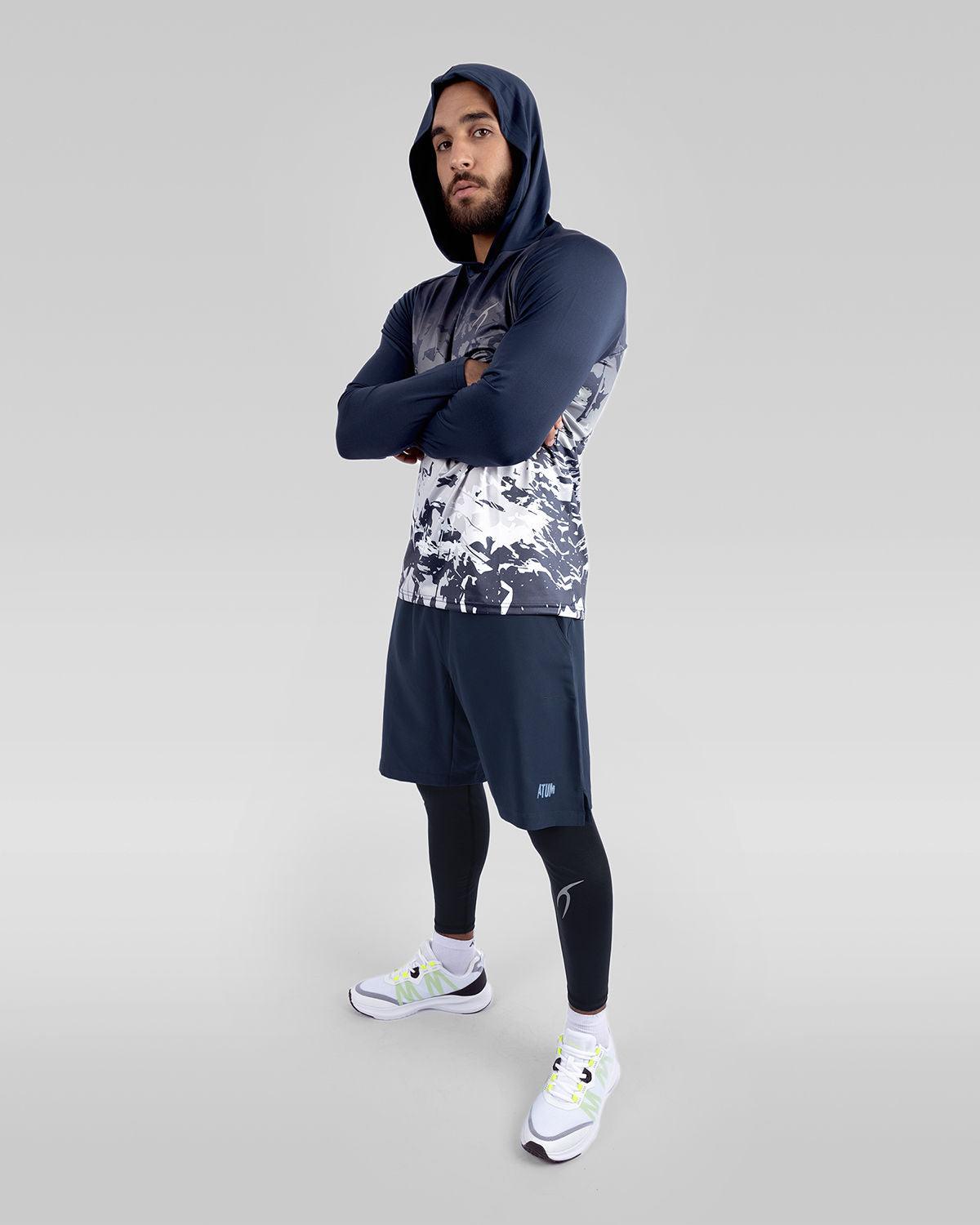 Photo by 𝗔𝗧𝗨ð�— SPORTSWEAR ® on December 20, 2022. May be an image of 1 men wear navy/white training hooded t-shirt, and navy training shorts with white shoes.