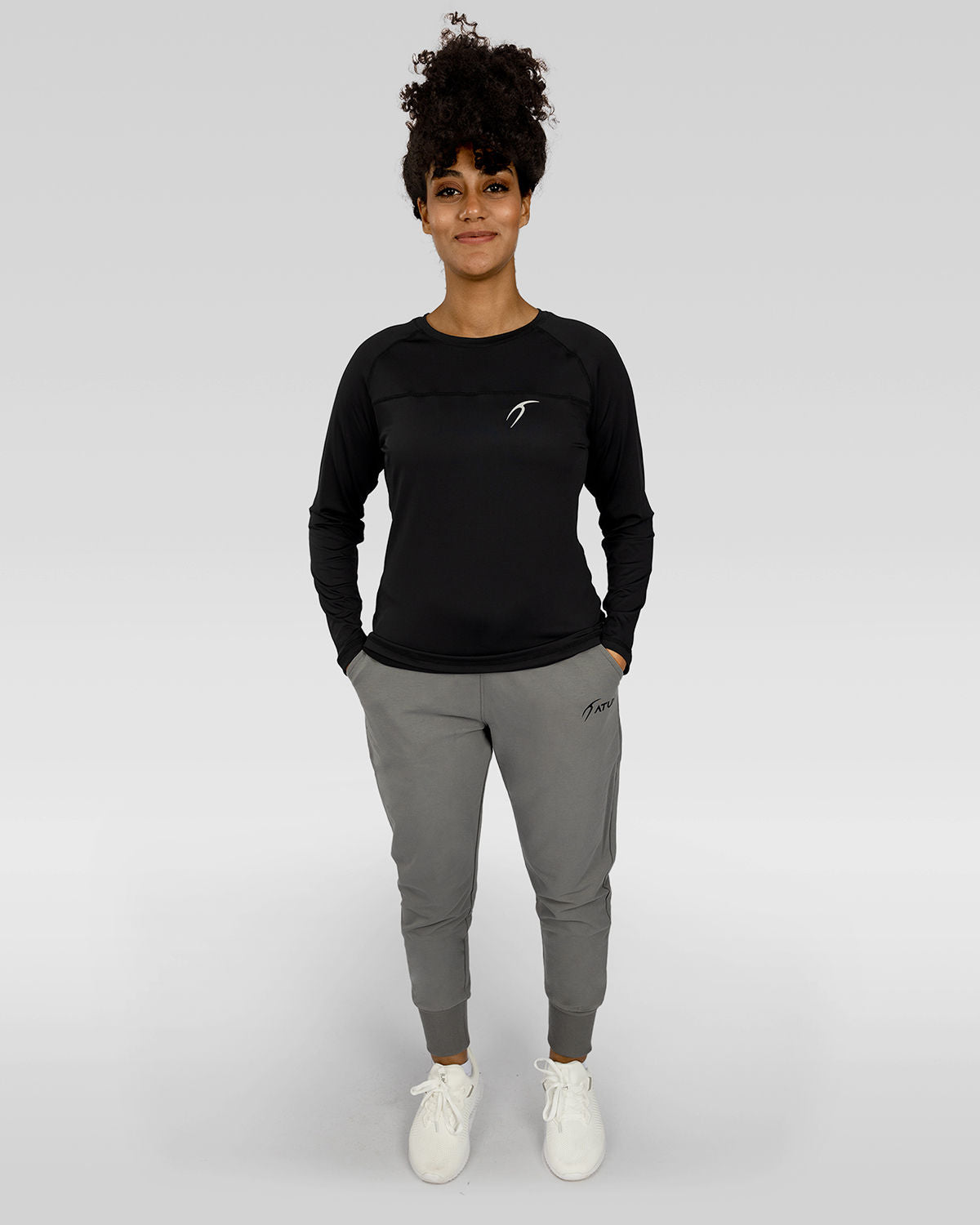 Photo by ð—”ð—§ð—¨ð— SPORTSWEAR Â® on December 20, 2022. May be an image of 1 woman wear black training t-shirt, gray sweatpants and white shoes.