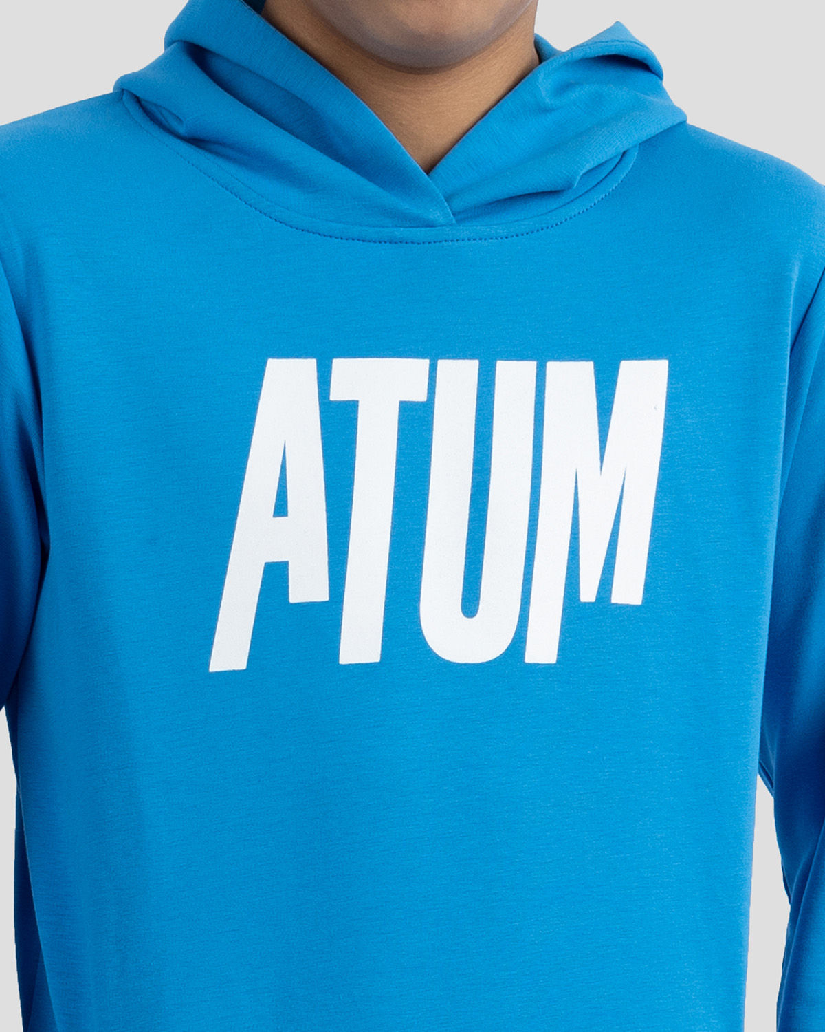 Photo by ð—”ð—§ð—¨ð— SPORTSWEAR Â® on December 20, 2022. May be an image of 1 boy wears a blue sweatshirt and a text said '' Atum''.