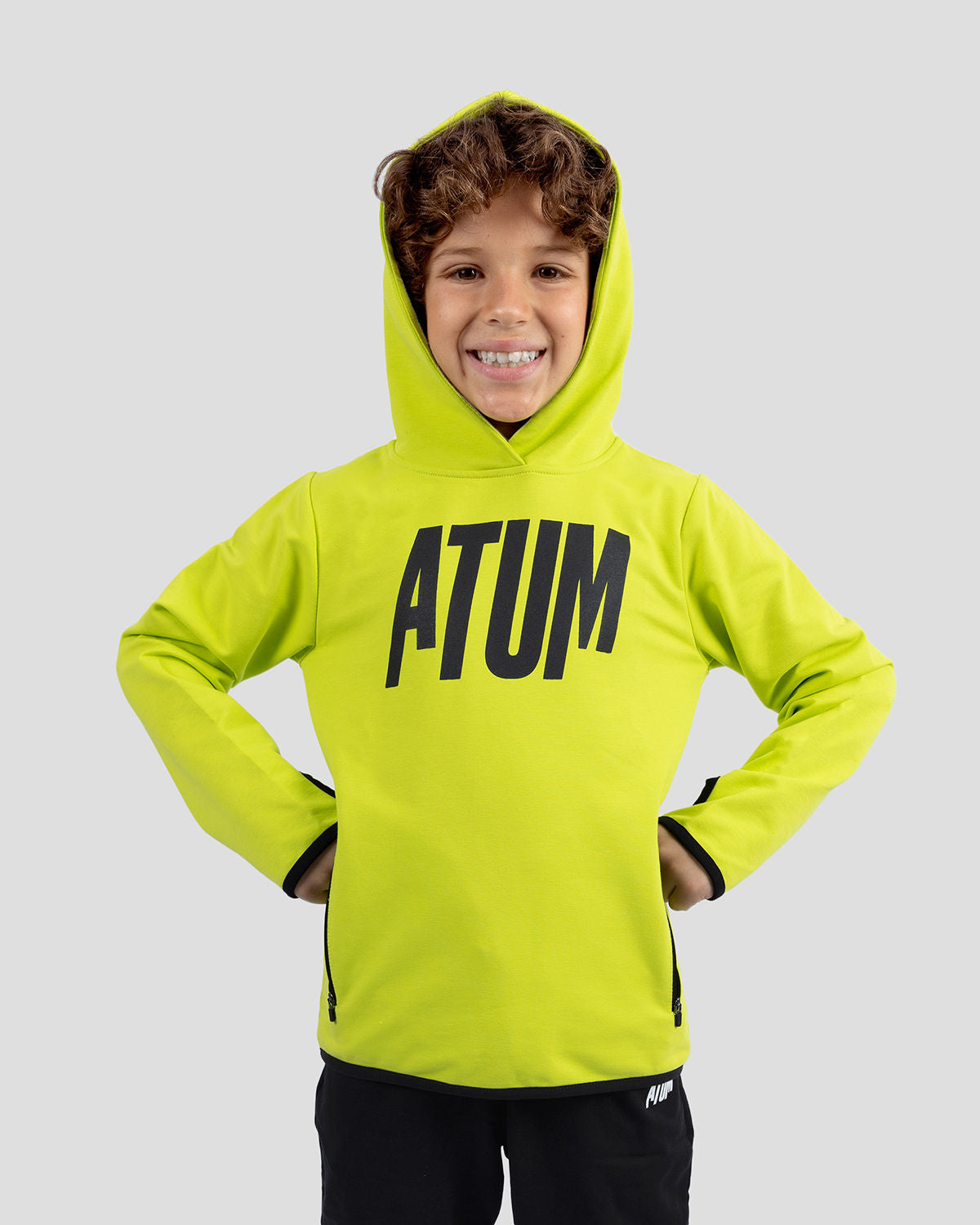Photo by 𝗔𝗧𝗨ð�— SPORTSWEAR ® on December 20, 2022. May be an image of 1 boy wears a green sweatshirt and a text said '' Atum''.