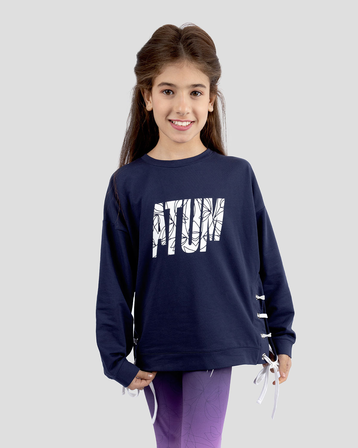 Photo by ð—”ð—§ð—¨ð— SPORTSWEAR Â® on December 20, 2022. May be an image of 1 girl wears navy sweatshirt and printed Atum.